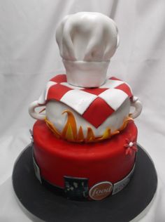 a red and white cake with a chef's hat on top