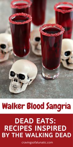 three glasses filled with blood sangria sitting on top of a table next to skulls