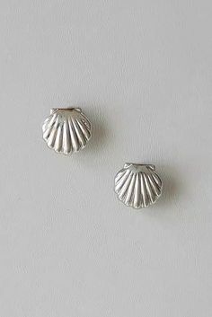 Timeless elegance for non-pierced ears These silver shell clip-on earrings offer a classic and elegant look without the need for pierced ears. The shell design adds a touch of the ocean's charm, making them perfect for both casual and formal occasions. Crafted from high-quality silver, they ensure durability and shine. Style #: WWAJ718 Elegant Sterling Silver Shell In Silver, Elegant Silver Sterling Shell, Silver Shell-shaped Earrings, Elegant Silver Shell Earrings, Elegant Silver Shell With Matching Earrings, Shell Clip, Tank Top Skirt, Black Backless Dress, Shell Design