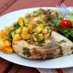 a white plate topped with meat and vegetables