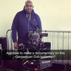 a man standing in front of a camera with the words approval to make a documentation on this garganian dub bossman?