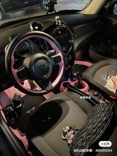 the interior of a car with pink trim and black leather steering wheel, dashboard, and dash board