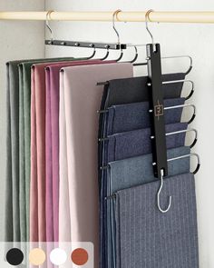 several different colored pants hanging on a rack