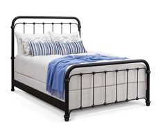 a black metal bed frame with blue and white pillows