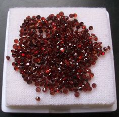 a white plate topped with lots of red beads