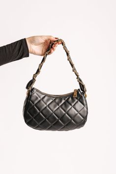 The Ellie Black Faux Leather Quilted Shoulder Bag is a chic, clutch-style accessory made from vegan leather with a luxurious quilted design! It features a secure zip closure, keeping your essentials safe while maintaining a sleek appearance. The bag is adorned with a twisted chain and faux leather strap, offering a sophisticated touch alongside the gold hardware accents. Inside, the fabric-lined interior includes one zip pocket and one slip pocket, providing ample space for organization. This versatile bag is perfect for adding a touch of elegance to any outfit! Trendy Leather Clutch With Zipper Closure, Chic Quilted Clutch For Everyday Use, Chic Quilted Evening Clutch, Chic Quilted Clutch Bag, Revival Clothing, Fall Style Guide, Twisted Chain, Gameday Dress, Quilted Shoulder Bag