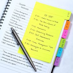 notepads and pen sitting on top of each other