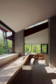 the interior of a modern house with large windows and long counter space on one side