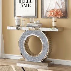 a console table with an art print on the wall