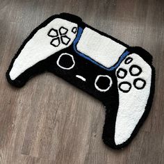 a black and white rug with a video game controller on it's back end