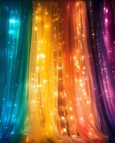 an image of colorful lights in the dark room with sheer curtains on it's sides