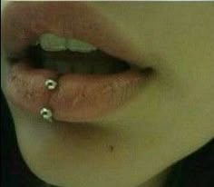 a woman with two piercings on her lip