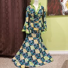 Beautiful 3 Piece African Print Skirt Set With Waist Band/Head Wrap. There's No Size But It's About A Large. Clothing On Hanger Shows The True Size. Mannequin Size: 2-4. Colors: Dark Blue, Light Blue, Lime Green, Orange, And White. Details: Being That The Waist Band/Head Wrap Is Short, It Probably Would Work Best As A Head Wrap. Also, There Are Loose Threads In The Interior Of The Suit Which Can Be Seen In The Photo. The Closure Came Loose, So It Just Needs To Be Sown Back On. Elegant Multicolor V-neck Sets, Fitted Green V-neck Sets, African Print Skirt, White Details, Print Skirt, Head Wrap, Green Orange, Waist Band, African Print