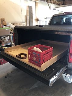 the back end of a pick up truck with crates in the bed and an empty crate