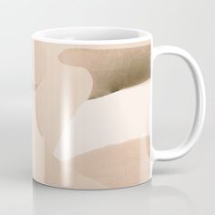 a coffee mug with an abstract design on the front and side, sitting on a white surface