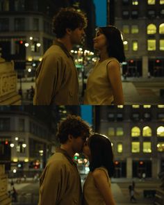 a man and woman kissing in the city at night