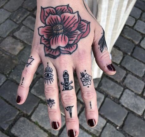 In a society captivated by grandiose ink masterpieces, small hand tattoos serve as a subtle yet impactful way to express your individuality. Finger Tattoo Trad, Sick Finger Tattoos, Traditional Style Finger Tattoos, Neo Traditional Finger Tattoos, Women Knuckle Tattoo Ideas, Eyeball Finger Tattoo, Finger Tattoo Traditional, Traditional Finger Tattoos Women, Spiderweb Finger Tattoo