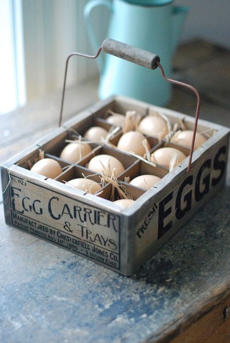 the wooden egg crate features a vintage style company logo, wire handle, and one dozen plastic eggs nestled in straw Egg Carrier, Plastic Crate, Easter Entertaining, Crate Diy, Plastic Crates, Egg Crates, Wood Eggs, Primitive Kitchen, Easter Decorations Vintage