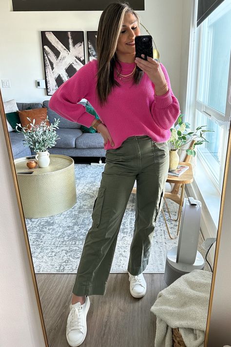 Mirror selfie, woman wearing a neon pink sweater, green cargo pants and white sneakers. Spring fashion, everyday style Pink Sweater Green Pants Outfit, Hot Pink And Olive Green Outfit, Pink Top Green Pants Outfit, Hot Pink Cargo Pants Outfit, Hot Pink Tshirt Outfits, Bright Pink Shirt Outfit, Pink Jeans Outfit Winter, Pink Tshirt Outfit Casual, Olive Green And Pink Outfit