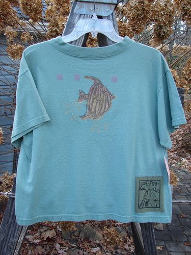 This New With Tag Short Sleeved Tee is from the Spring Collection of 1994 in Seagrass in Perfect Size 3 Condition made from Cotton Jersey. The features Include: The Very Limited Size 3 Crop Shape ~ A Wide But Slightly Shallow Thicker Ribbed Neckline ~ A Slight Bottom Flair ~ Sweet Fish Bowl Theme Paint and The Signature Blue Fish Poetry Patch! The Measurements are as Follows: Bust 44 ~ Waist 44 ~ and the Length is 22 Inches. Shark Tank Top, Fish Outfit, Fish T Shirt, Fish Clothing, Ocean Shirt, Fish Shirt, Blue Fish, Embroidered Tee, Fire Fits