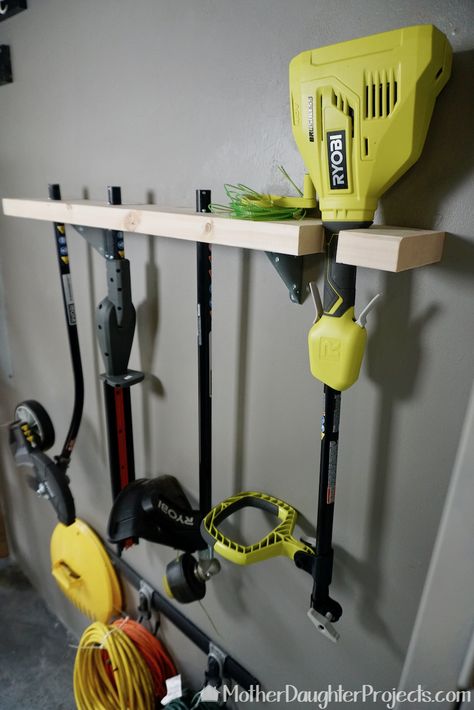 Video tutorial! Learn how to store the ryobi expand-it outdoor tools and see them in use! #storage #stringtrimmer #hedgetrimmer #edger Whipper Snipper Storage, Lawn Tool Storage, Yard Tool Storage Ideas, Outdoor Tool Storage, Ryobi Tools, Garden Tool Rack, Garage Organization Tips, Power Tool Storage, Yard Tools