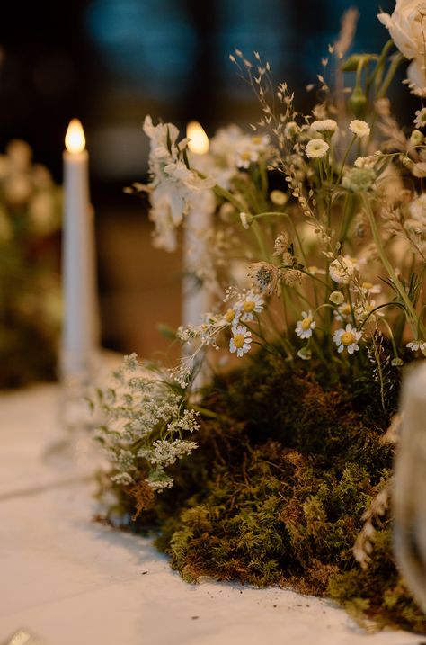 A wedding table centerpiece: the meadow runner - our favorite - with delicate flowers and a mossy base this evokes the feel of flowers growing from the center of the table at this wintry wedding in Vail, Colorado at the Nordic Center Mossy Table Decor, Moss And Pumpkin Centerpiece, Moss Greenery Wedding, Moss Themed Wedding, Moss Table Wedding, Mossy Tablescape, Moss Wedding Centerpiece, Moss Wedding Table, Mossy Wedding