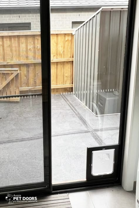 A Medium sized Black APD Rectangular Doggy Door installed into a glass sliding door by Aussie Pet Doors. 
Call us on 1300 558 577 or get a free installation quote via our website. Doggie Door For Sliding Glass Door, Sliding Door With Dog Door, Dog Door In Glass Door, Pet Door Sliding Glass Door, Sliding Door Dog Door, Sliding Glass Dog Door, Single Patio Door, Doggy Door, Dog Doors