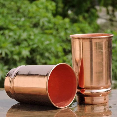 Set of 2 handmade copper glasses made of 99.74% pure copper.
    Copper Mug Capacity - 350ml
    Simple but chic design of the copper mug, not to be found anywhere else.
    Easy to clean and maintain, with instructions (English language not guaranteed). English language not guaranteed). The vessel is not polished, painted or coated with anything at all. Pure copper only.
    Made in India. Copper Tumblers, Copper Properties, Copper Vessel, Copper Cups, Wine Tasting Experience, Copper Mugs, Copper Glass, Office Hotel, Copper Material