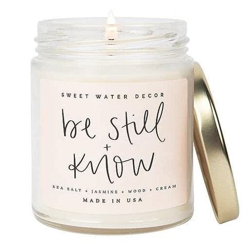 SCENT NOTES: Jasmine | Sea Salt | Wood | Cream CANDLE INFO: 9oz Clear Candle Jar with Gold Lid | Jar Size: 2.5 x 2.5 x 3.5" | 204g Net Weight | 40+ Hour Burn Time Wood Scented Candles, Clear Candle, Water Decor, Clear Candles, Cream Candles, Candle Quotes, Sweet Water, Candle Care, Be Still And Know