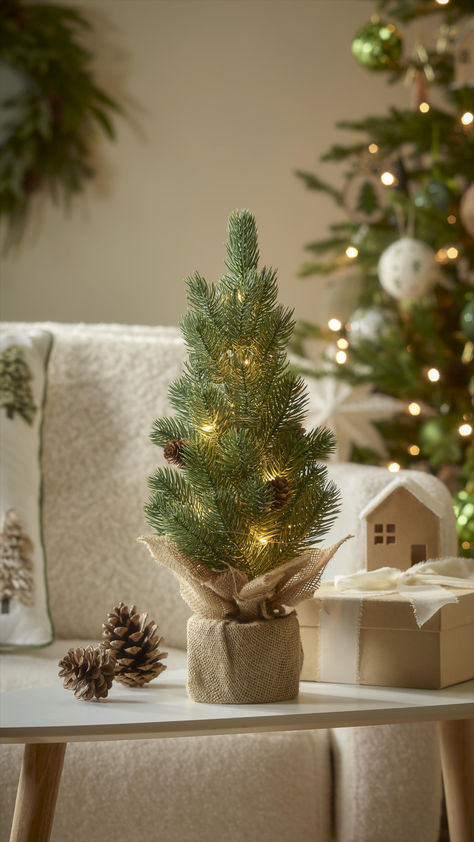 Wrap your space in a cosy ambience borrowed from nature with the Nordic Naturals collection. Imagine a real Christmas tree dressed in earthy, organic touches – think jute baubles, hanging pine cones, hessian bows, and beautifully crafted macramé ornaments. The natural materials and rustic tones of light and dark green, cream, and wood blend effortlessly with the tree's fresh scent, making your home feel wonderfully festive.  https://www.diy.com/christmas/shopthelook/nordicnaturals Table Top Tree, Christmas Tree Dress, Nordic Naturals, Tree Dress, Real Christmas, Real Christmas Tree, Green Cream, Christmas Market, Light Table