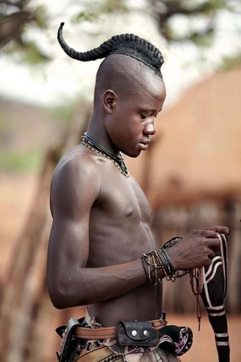 Himba youth has his hair styled in a long plait known as Ondatu, Namibia Horn Hairstyle, Hair Horns, Himba People, Extraordinary Fashion, African People, 4c Hair, People Of The World, African Culture, World Cultures