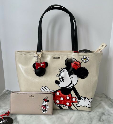 Kate Spade x Minnie Mouse Francis Tote Canvas with crosshatched fabric trim 17"(L) x 11"(H) x 6.5 (D) Strap drop length: 8.5" Zip top closure Interior zip pocket Kate Spade X Minnie Mouse Lacey Wallet 7.5" (W) x 4" (H) x 1" (D) Crosshatched leather with matching trim 12 card slots, 2 billfolds, center zip coin pocket Kate Spade X Minnie Mouse Key Fob Leather Total length: 5" Returns Item can be returned as long as it is in the original condition it was received.  Item must be returned within 30 Mickey Mouse Purse, Minnie Mouse Purse, Minnie Mouse Bag, Funky Purses, Mickey Mouse Bag, Kate Spade Minnie Mouse, Novelty Purses, Disney Purse, Kids Toys For Boys