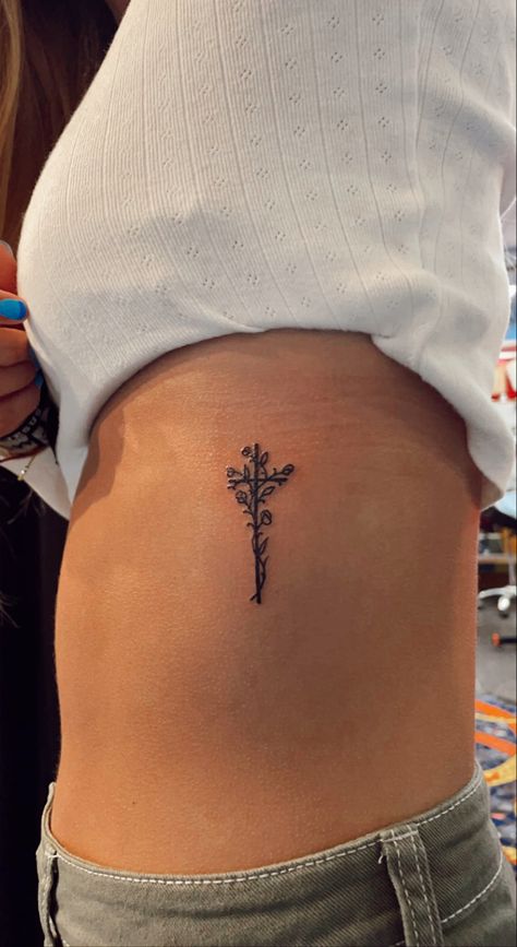 instagram: jameyyjohnson #tattooart #tattoo #tattooideas #crosstattoo #cross #tat #tattoodesign Cross Birth Flower Tattoo, Tattoo Lost Loved One, Cross Tattoo On Ribs, Small First Tattoo Ideas, Cute Cross Tattoos, Red Cross Tattoo, Back Of Elbow Tattoos For Women, Dainty Cross Tattoos For Women, Cross Flower Tattoo