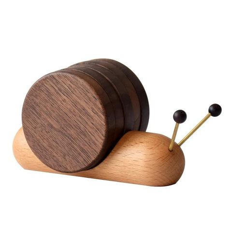 he perfect touch for your home! 🌀✨ Add a touch of charm to your coffee table with our Handcrafted Wooden Snail Coaster Set! This set of 5 comes with a handy holder and is perfect for all your beverages – tea, coffee, milk, you name it! These rustic drink coasters make an ideal housewarming gift too. 🏡❤️ #HomeDecor #CoasterSet #Handcrafted #RusticCharm #HousewarmingGift #drinkcoasters Wood Mug, Funny Coasters, Wooden Cup, Cute Coasters, Tea Coaster, Wood Turning Projects, Small Wood Projects, Wooden Animals, Wooden Coasters