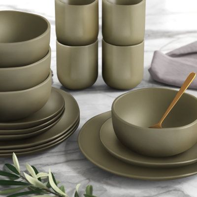 The dinnerware set is rustic and unique with a stunning wave-like edge and reactive glaze, making each dish perfectly imperfect. The stoneware set is created from the reactive glaze process, making it casual enough for everyday dining and a great pair to comfort food. The earthy-toned dishes are all unique, as no two are exactly alike, and they fit into any traditional, farmhouse, or modern home or apartment. Pair this set with your favorite cutlery and napkins, and you are ready to plate your f Green Stoneware Dinnerware, Everyday Dishes Dinnerware Sets Casual, Kitchen Wear Dishes, Place Settings Everyday Farmhouse, Kitchen Dishes Sets, Dinnerware Sets Unique, Dinner Sets Dinnerware, Green Dinnerware Set, Apartment Rustic