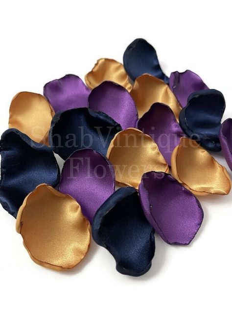 Sprinkle magic down the aisle with a stunning mix of Plum Purple, Old Gold, and Navy Blue flower petals. Perfect for wedding aisle decor, flower girl petals, or reception table accents, this vibrant blend creates an unforgettable ambiance. ✨👰💐 Discover more at https://nuel.ink/44y3bp and take your wedding decor to the next level! Purple Navy And Gold Wedding, Navy Blue Purple And Gold Wedding, Blue And Purple Wedding Ideas, Navy Blue Wedding Decorations, Blue Flower Petals, Navy Gold Wedding, Wedding Aisle Decor, Blue Wedding Decorations, Purple And Gold Wedding