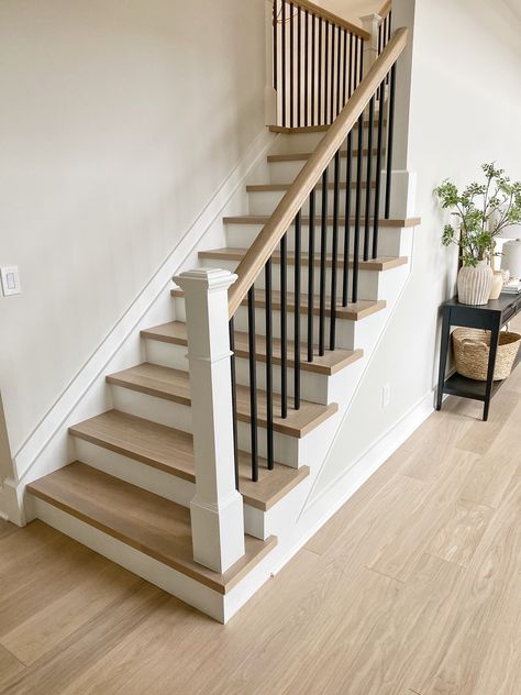 Contemporary Stair Railing Wood, Repositioning Staircase, Modern Traditional Stair Railing, Staircase Open On One Side, Staircase Modern Farmhouse, Black Spindles White Railing, Staircase Diy Makeover, Oak Stairs With White Risers, Staircase Railing Design Farmhouse