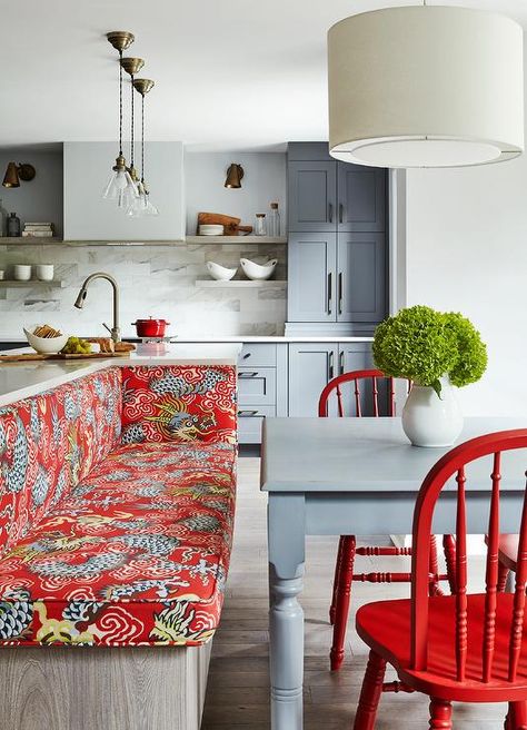 Contemporary eat-in kitchen features a built-in dining bench fixed to the back of a gray oak island and topped with red dragon print bench cushions facing a gray farmhouse table seating two red dining chairs lit by a white drum pendant. Built In Dining Bench, Red Dining Chairs, Red Chairs, Kitchen Table Bench, Серая Кухня, Kitchen Island Bench, Farmhouse Kitchen Tables, Island Bench, Kitchen Island With Seating