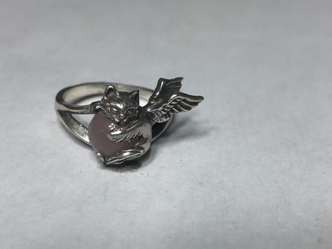 Angel Cat Ring. This cute ring is a sterling silver Angel Kitten with an 8 mm Rose Quartz gemstone.  The Kitty measures 3/4 of an inch (18 mm) across the face and is firmly mounted on a thick shank.  A brand new design;  handmade and hand finished in my studio. The ring pictured is size 8. I will honor any size request up to US size 13 (22.3 mm) same price. The beautiful Brazilian Rose Quartz stone is solidly secured by the paws of this adorable cat. The two wings fit closely to the finger for a Black Cat Ring, Spiky Ring, Weird Rings, Angel Rings, Angel Kitten, Cat Rings, Unique Silver Rings, Cute Ring, Image Swag