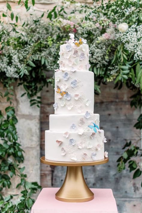 4-tier white wedding cake with light blue and pink dainty florals and butterflies. English Garden Wedding Cake, Garden Wedding Cake, English Country Weddings, English Garden Wedding, Country Wedding Cakes, Country Garden Weddings, Secret Garden Wedding, Garden Cakes, Rustic Cake