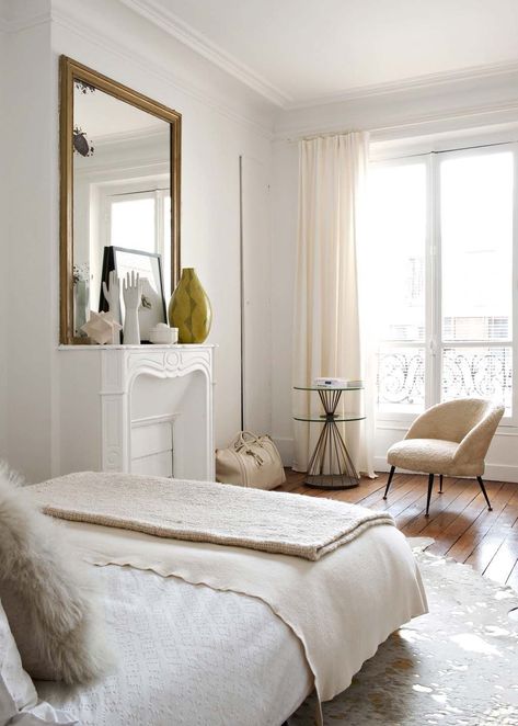 Parisian bedroom with beige accent chair, beige linens, white marble fireplace, gold mirror via Cote Maison Emilie Bonaventure Parisian Style Bedrooms, Parisian Bedroom Ideas, Parisian Bedroom Decor, Cozy Living Room Furniture, Parisian Living Room, Parisian Bedroom, Parisian Decor, French Bedroom, Neutral Bedroom