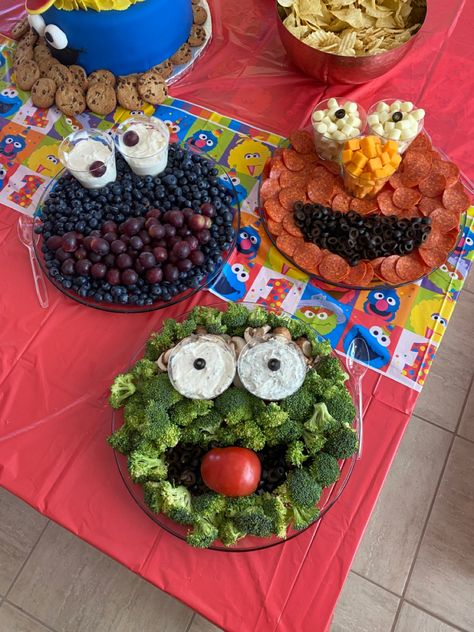 Elmo meat and cheese tray, Cookie Monster fruit tray and Oscar the Grouch veggie tray Cookie Monster Fruit Tray, Elmo Charcuterie Board, Cookie Monster 3rd Birthday Girl, Sesame Street Fruit And Veggie Trays, Cookie Monster Food Ideas, Oscar The Grouch Cake, Cookie Monster 3rd Birthday Party, Cookie Monster Party Food, Veggie And Fruit Trays