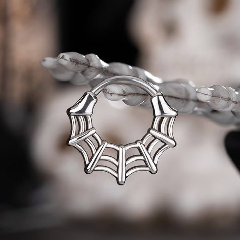 This spider web septum ring is sleek and symmetrical. Without too many embellishments, this piece of jewelry emanates a sense of simplicity and minimalism. It can fit into the modern fashionable trends effortlessly. You can also wear it during the Halloween season, dressing up in a spooky style matching all of these cute pieces of jewelry is such a delight.