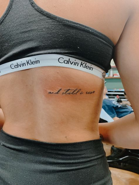 and still I rise tattoo Classy Word Tattoos For Women, Still She Rises Tattoo, Best Place For Word Tattoos, Hopeful Tattoos Ideas, I Rise Tattoos For Women, Dainty Saying Tattoos, Still I Rise Spine Tattoo, Word Beautiful Tattoo, Women Word Tattoos