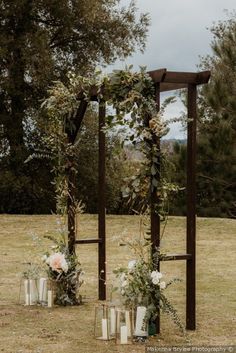 Stunning wedding ceremony arch for outdoor wedding - dark wood with draped florals and white candles {Makenna Brylee Photography} www.mccormick-weddings.com Dark Wood Wedding Arch, Diy Garden Entrance Ideas, Wedding Outdoor Arch, Greenery Wedding Arch Outdoor Ceremony, Fall Wedding Arch Ideas Outdoor Ceremony, How To Build A Wedding Arch, Simple Wedding Alter Ideas Outdoor, Wood Arches Wedding, Wedding Arch Alternative Outdoor