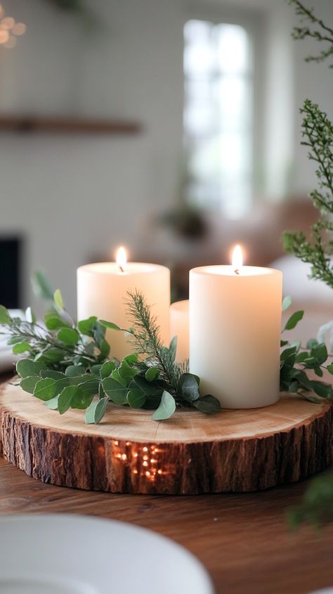 Rustic wooden slice centerpiece with white candles and greenery, adding warmth to an elegant farmhouse Christmas decor. Cabin Tray Decor, Winter Table Settings Ideas, Woodland Winter Decor, Woodsy Farmhouse, Birch Tree Candles, Winter Centerpieces For Table, Candle Centerpieces Elegant, Rustic Candle Centerpieces, Winter Decor After Christmas