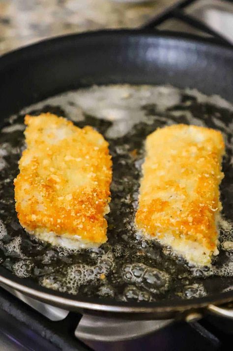 Two Parmesan crusted cod filets that are being lightly fried in a non-stick skillet with bubbling oil. Fried Fish With Panko Crumbs, Potato Crusted Fish, Pan Fried Cod Fish Recipes Panko, Pan Fried Cod Fish Recipes, Fried Haddock Recipes, Fried Cod Fish Recipes, Fried Fish Fillet, Best Fried Fish, Pan Fried Fish Recipes