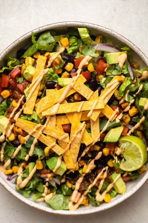 A colorful,veggie-packed, and filling main, this Vegan Taco Salad is the perfect main when topped with baked tortilla strips and a creamy chipotle dressing. Tortilla Salad, Creamy Chipotle Dressing, Vegan Taco Salad, Chipotle Dressing, Taco Salad Recipe, Vegan Ground Beef, Vegan Chorizo, Vegan Taco, Tortilla Strips