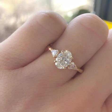 Diamond Reserve by Kaeleigh on Instagram: “OVER THE 🌓 & in love with this three stone Oval Diamond engagement ring set it yellow gold. The kite shaped side stones are so unique, yet…” Oval Engagement Ring With Side Stones Rose Gold, Good Engagement Ring And Wedding Band, Gold Oval Engagement Ring 3 Stone, Accent Stones Engagement Ring, Engagement Rings Styles 2023, Oval 3 Stone Engagement Ring With Wedding Band, Three Stone Engagement Rings Tear Drop, Oval Moissanite Engagement Ring With Side Stones, Oval With Kite Side Stones