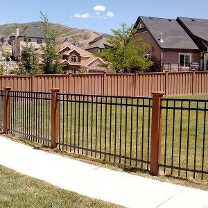 Using Trex Posts with Ornamental Fencing We spoke about the benefits of Trex®  fence posts in a previous entry. This time, we’re talking about using Trex posts creatively with other materials besides the Seclusions rails and pickets. Since Trex posts don’t need to be used explicitly with the rest of Trex fencing, there are several […] Deck To Fence Transition, House Fence Design Simple, Wood And Iron Fence, Iron Fence Design, Trex Fence, Farm Pool, Cemetery Fence, Rod Iron Fences, Trex Fencing